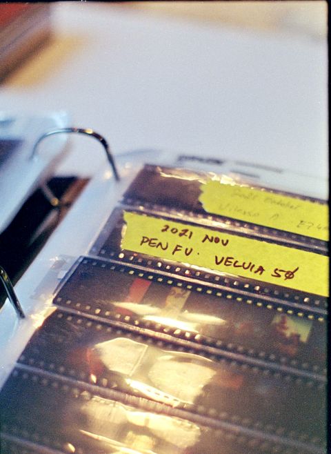PrintFile binder negative sleeves with 35mm film. I label the beginning of each film roll and the top of a page with masking tape, marked with the date, the film, and the camera.