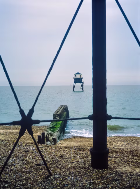 The outer lighthouse photographed through the pylons supporting the inner lighthouse.