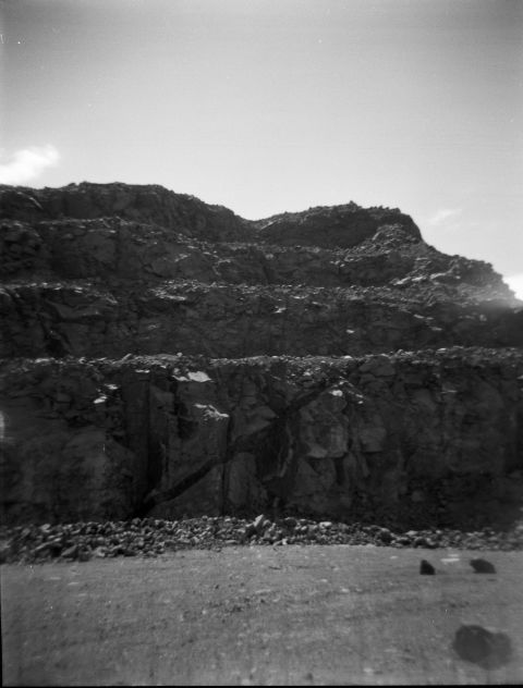 Basaltic intrusion cutting across quarry face.