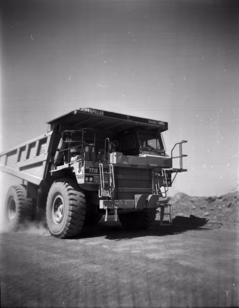 Cattapillar hauling aggregate fresh off the quarry face.