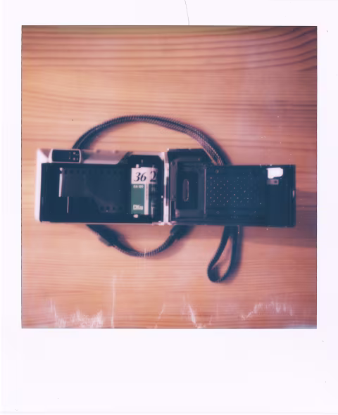 Loading film into Pentax Expio 140V is easy. Pop the door open by pulling the tab on the left and insert your 35mm film with its tip extended.