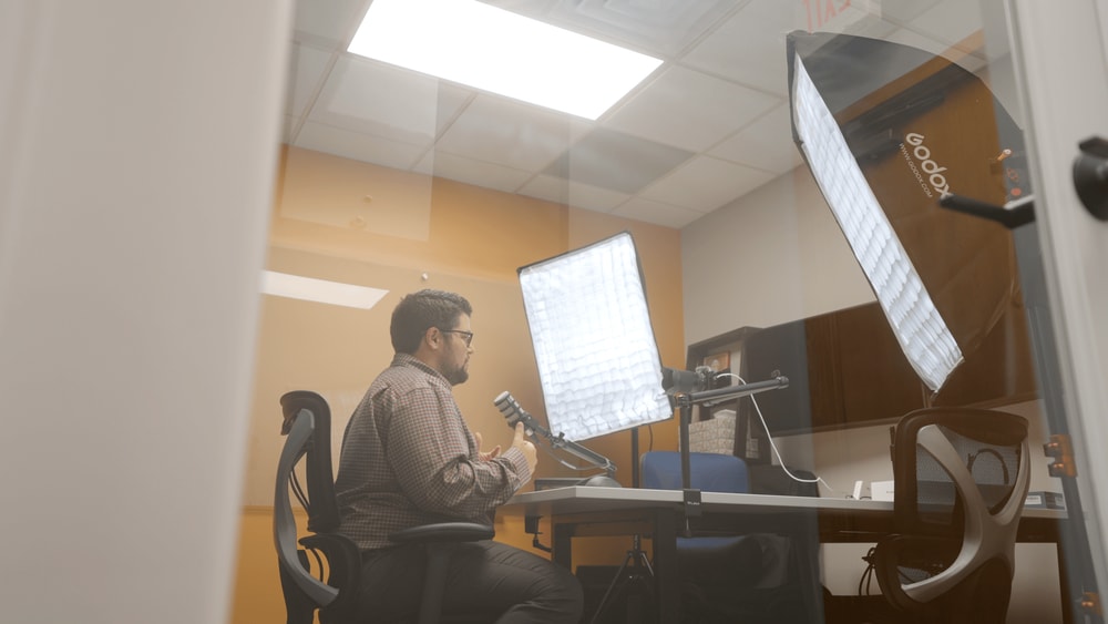 Anchor Group employee recording in a studio