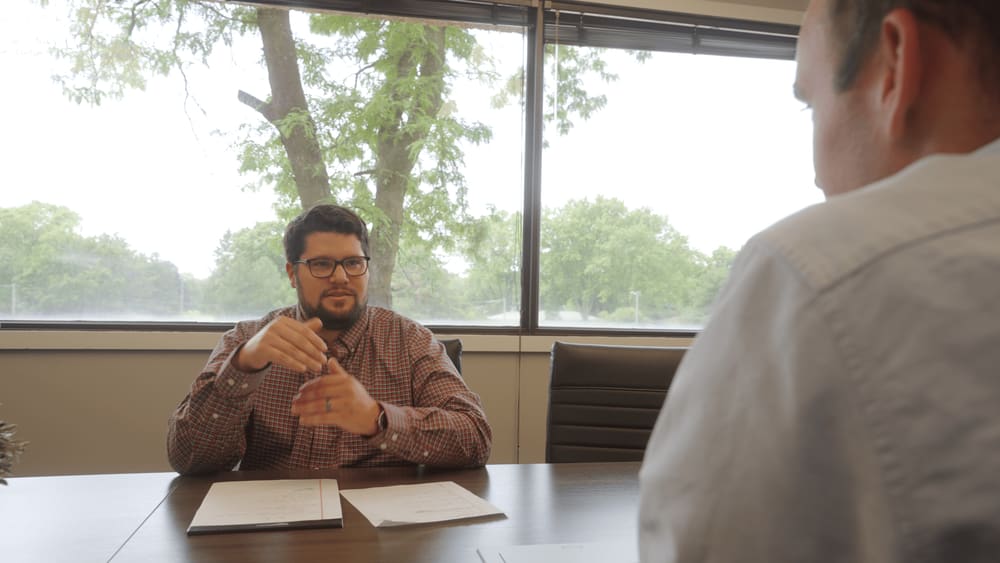 anchor group sitting with client at a table in a conference room