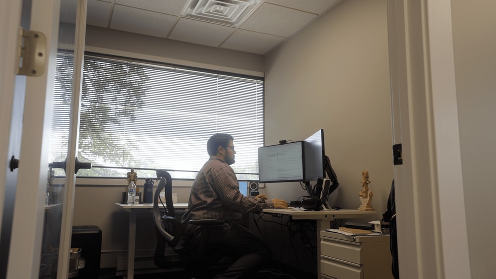 anchor group employee sitting in an office at a computer working