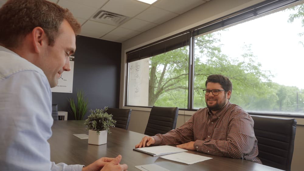 anchor Group employee sitting with a client