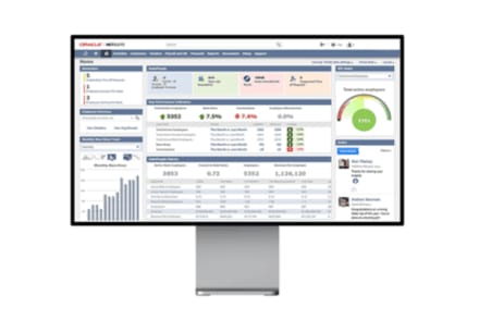 A computer monitor shows a data dashboard with various graphs and metrics for analysis.