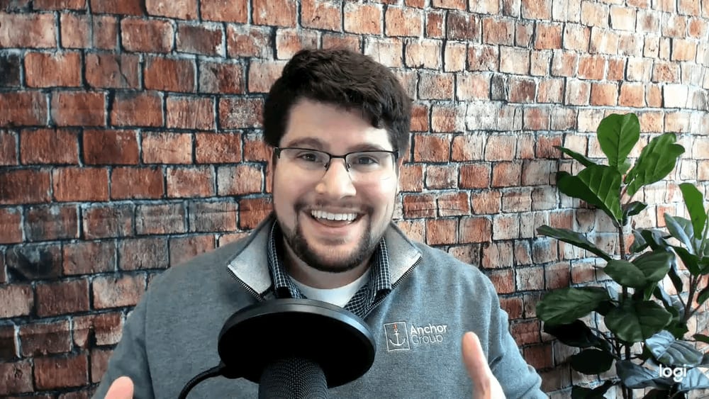 Caleb Schmitz speaking into a microphone.