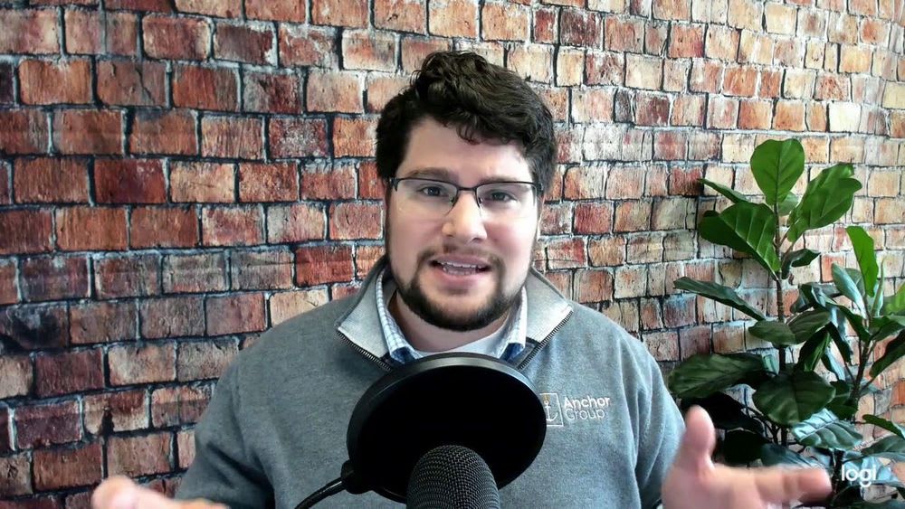 man speaking into a capera with a professional background