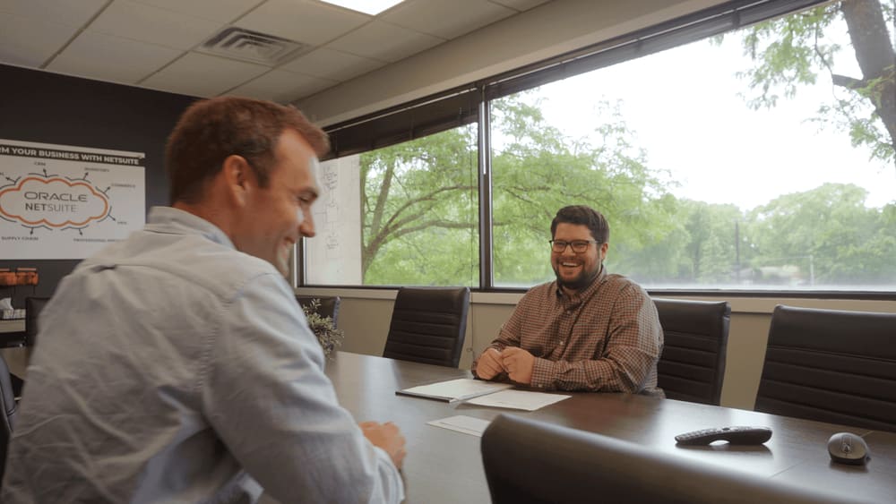 two man in business attire are collaborating in a professional setting.