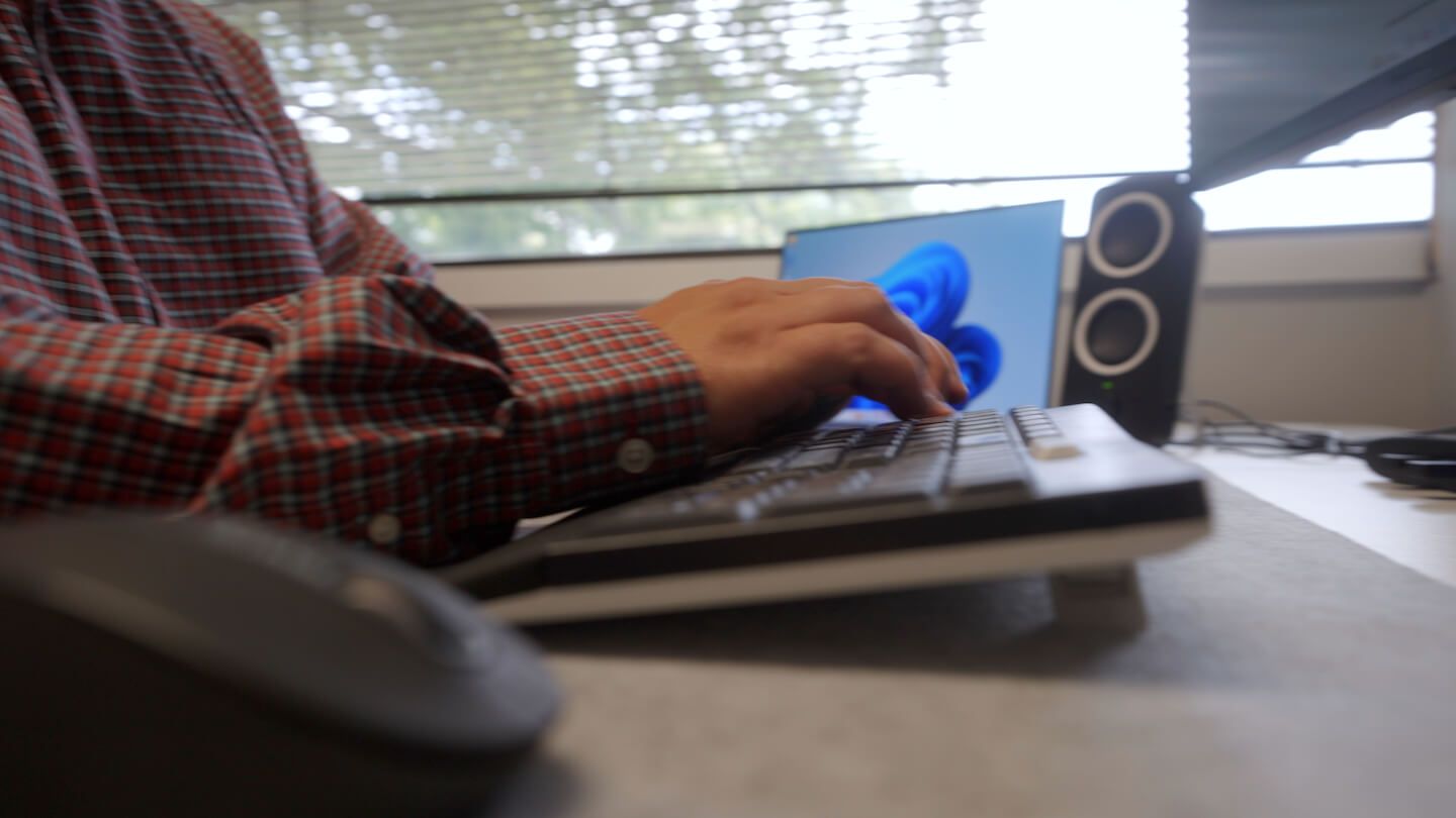 Anchor Group employee typing on keyboard.