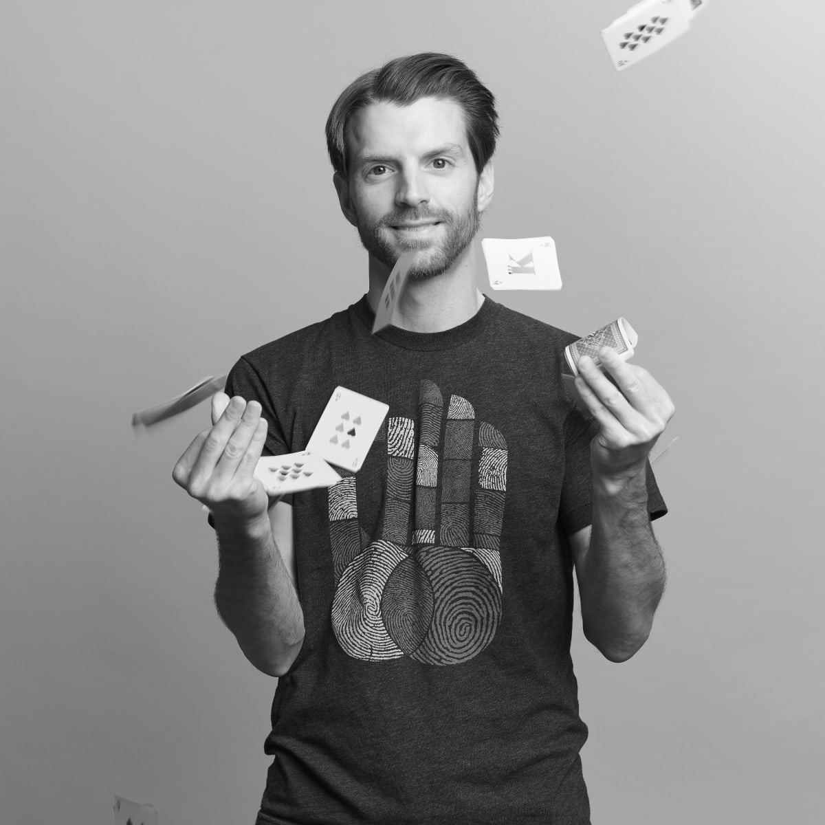 The designer Andy Stewart throwing playing cards into the air