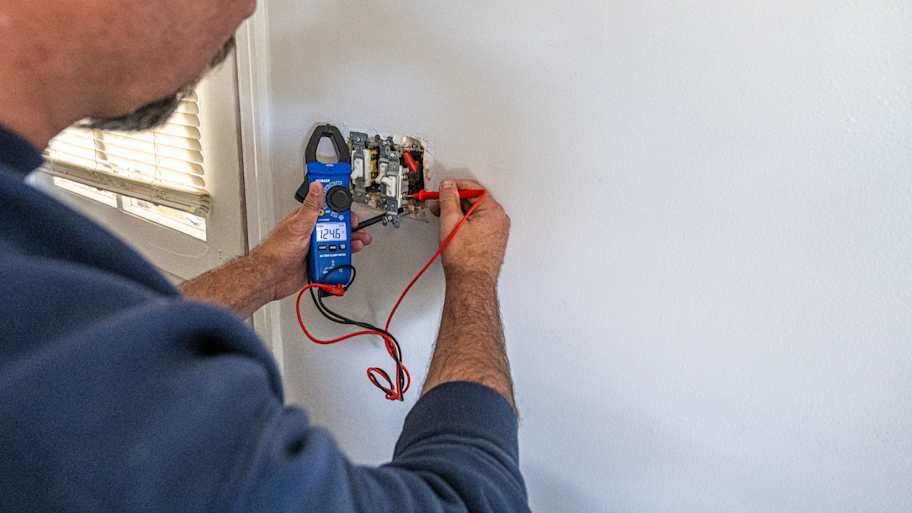 Electrician working on a light switch.
