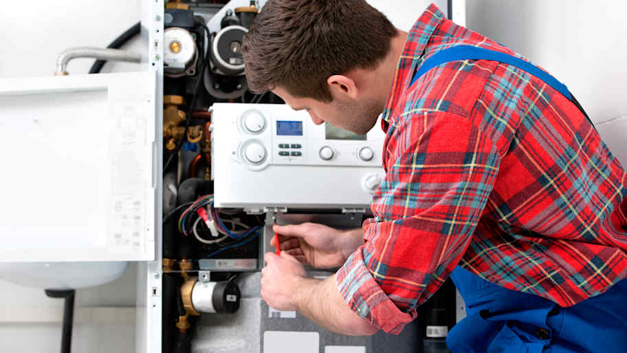 Technician servicing the gas boiler for hot water and heating