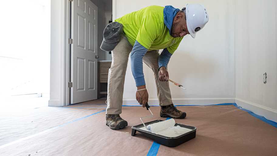 Worker getting ready to paint a wall
