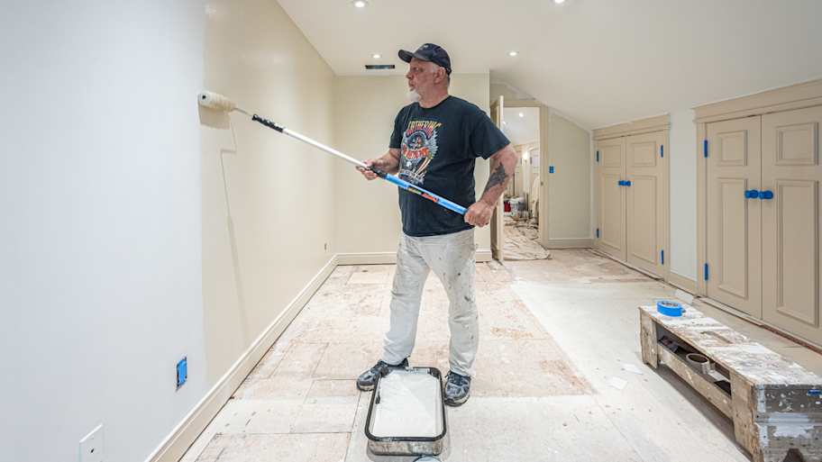  Man painting wall with roller