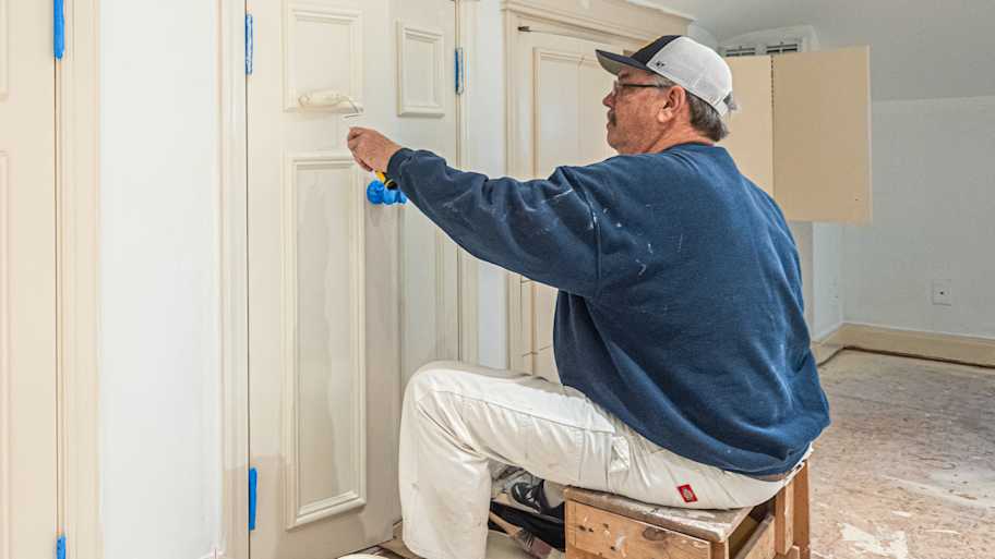 Man painting wooden door