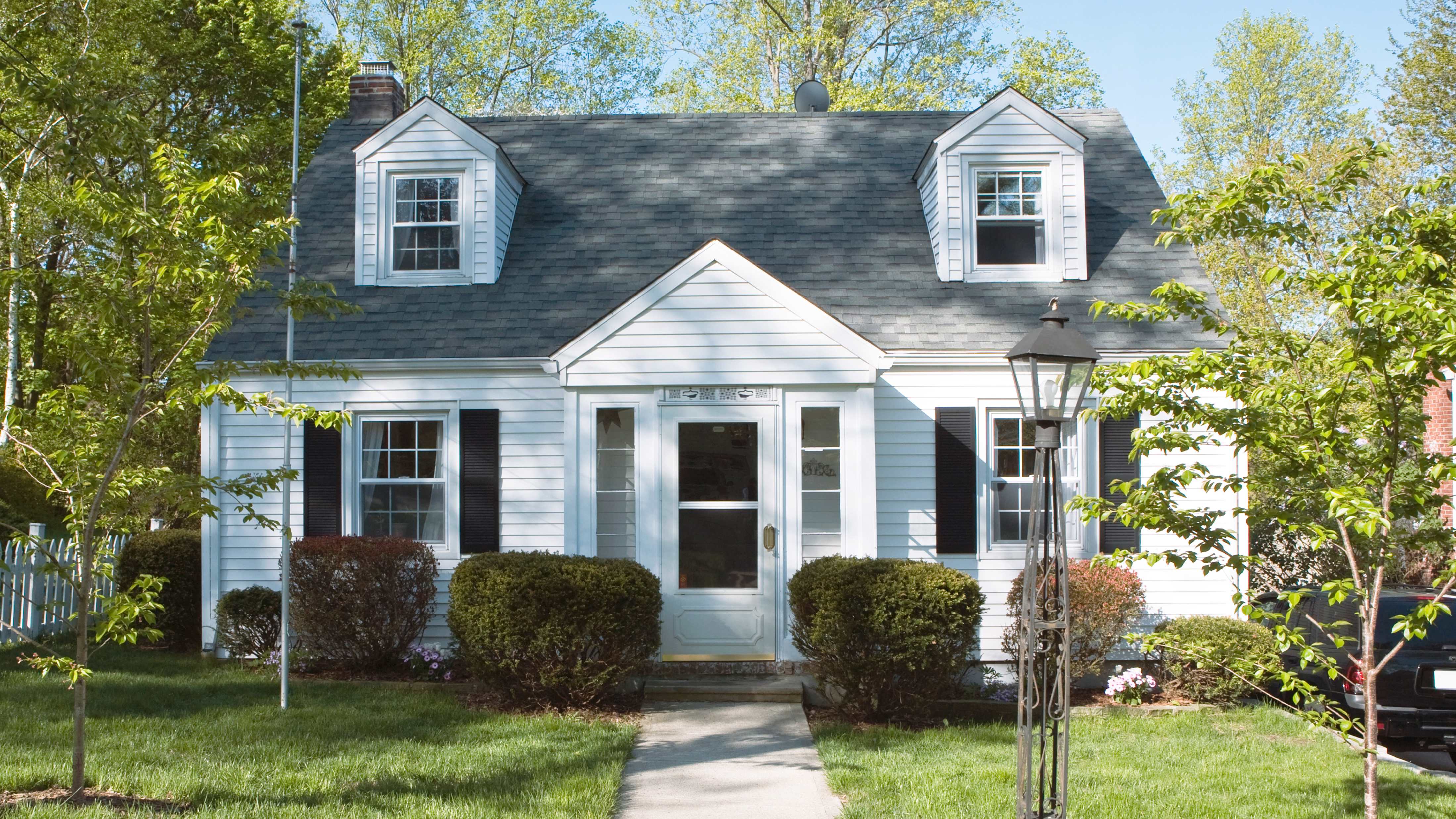 Single-family home with asphalt roof shingles and white siding   