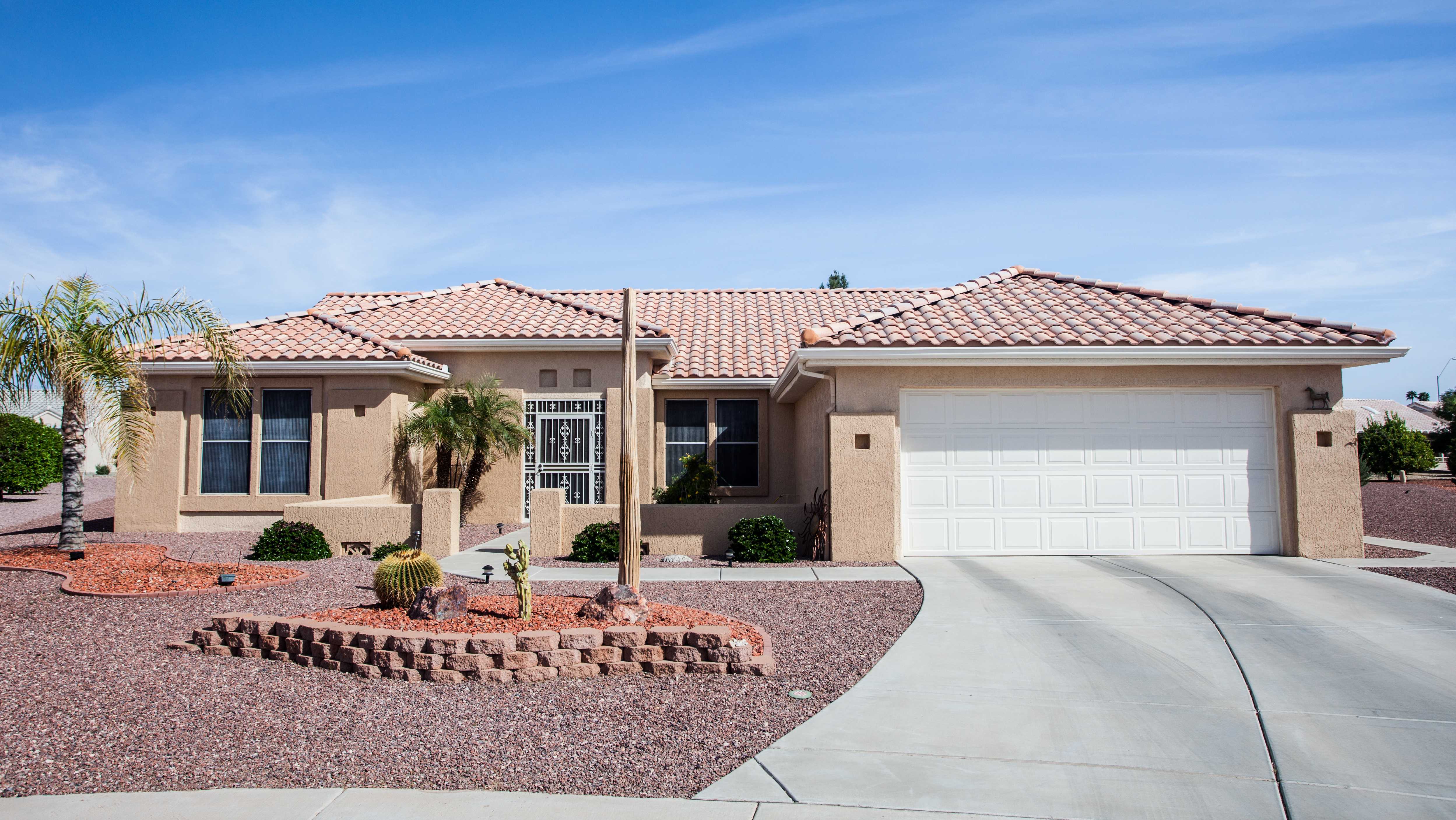 Arizona-style house with clay tile roof and xeriscape