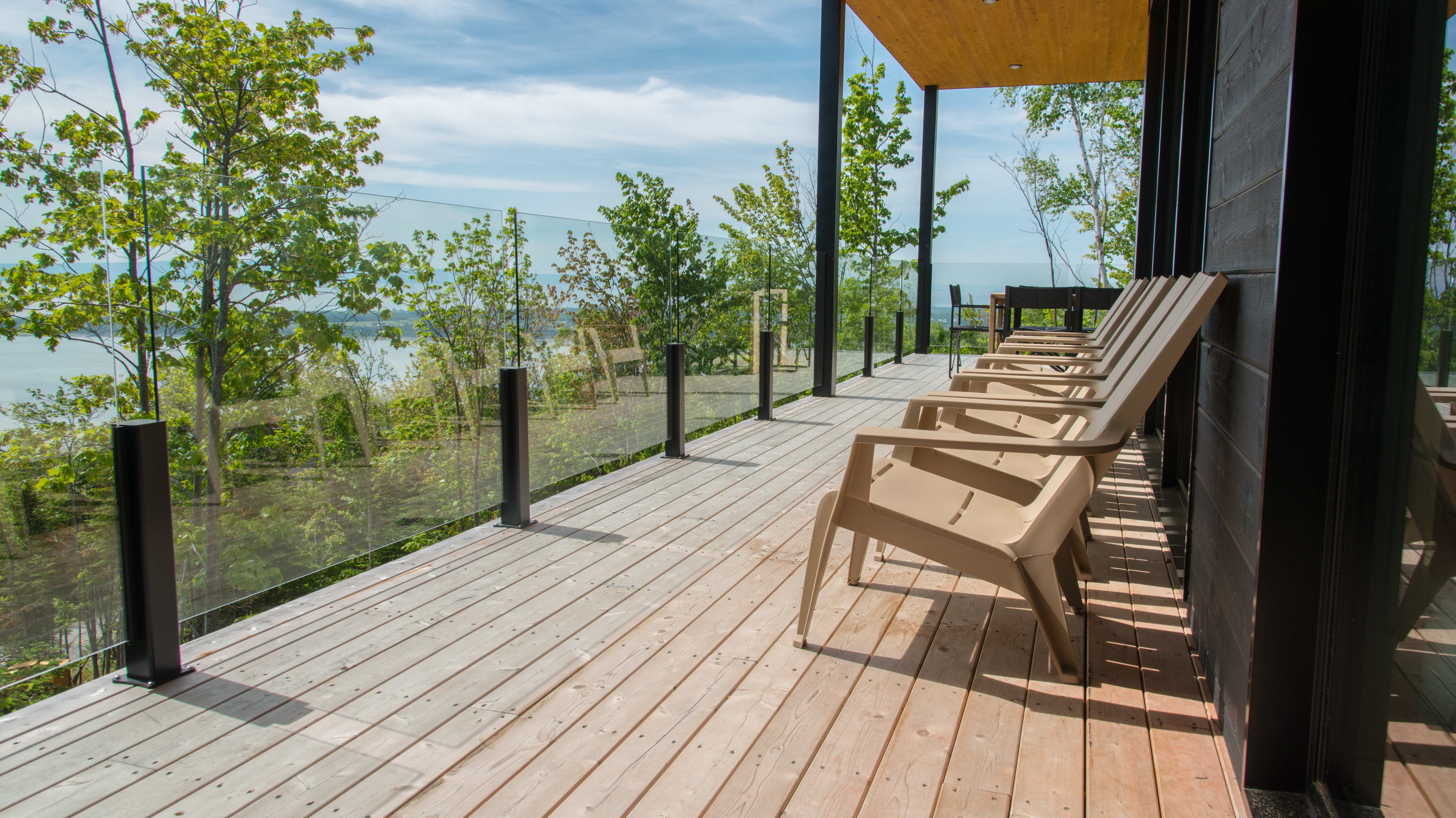 Modern deck with a beautiful view and a glass railing