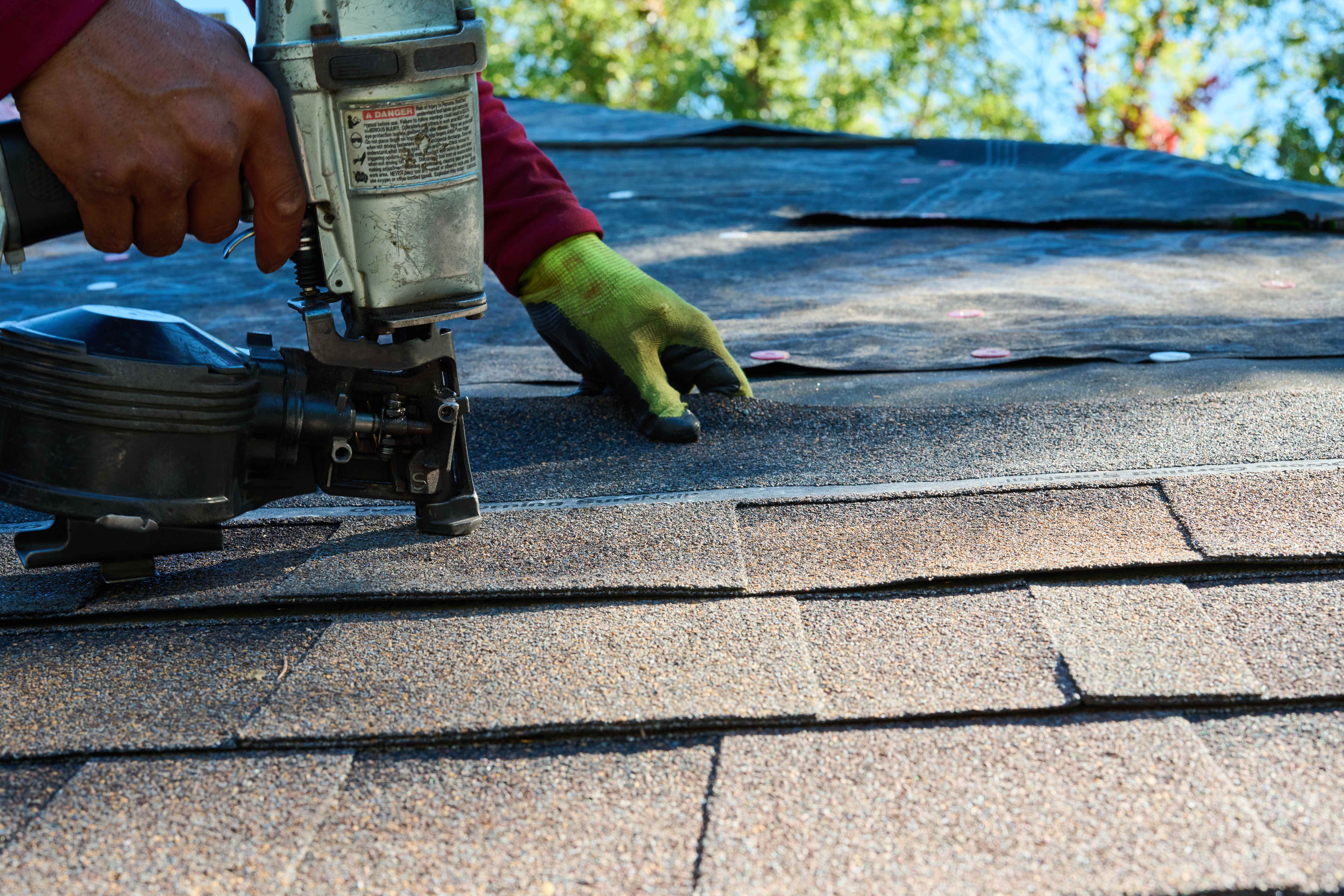 Shingles being applied to rooftop.