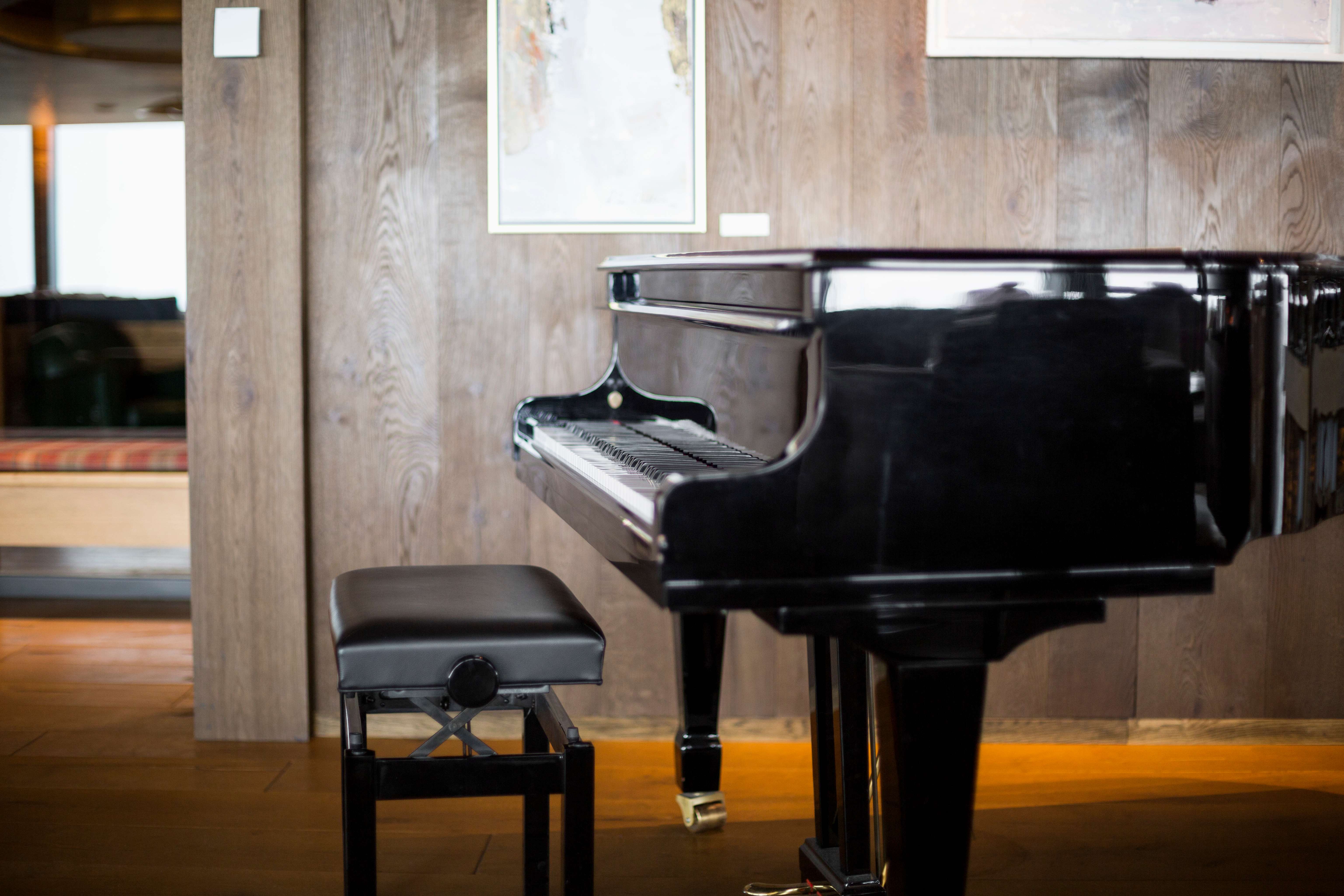 Elegant piano in a living room with stunning views of the Swiss Alps, showcasing the importance of careful piano moving and placement