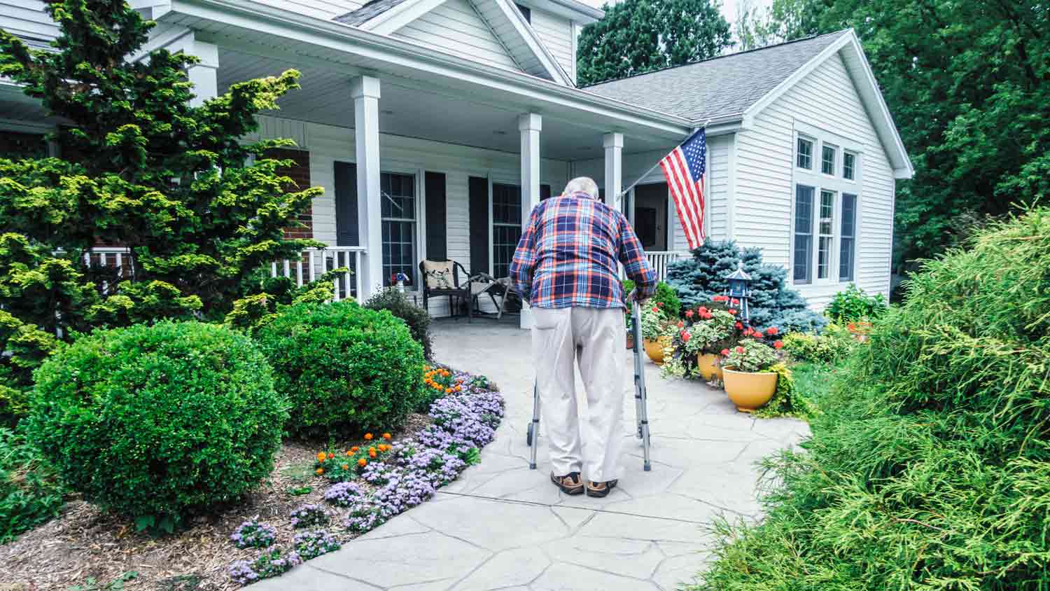 senior man walking home with walker