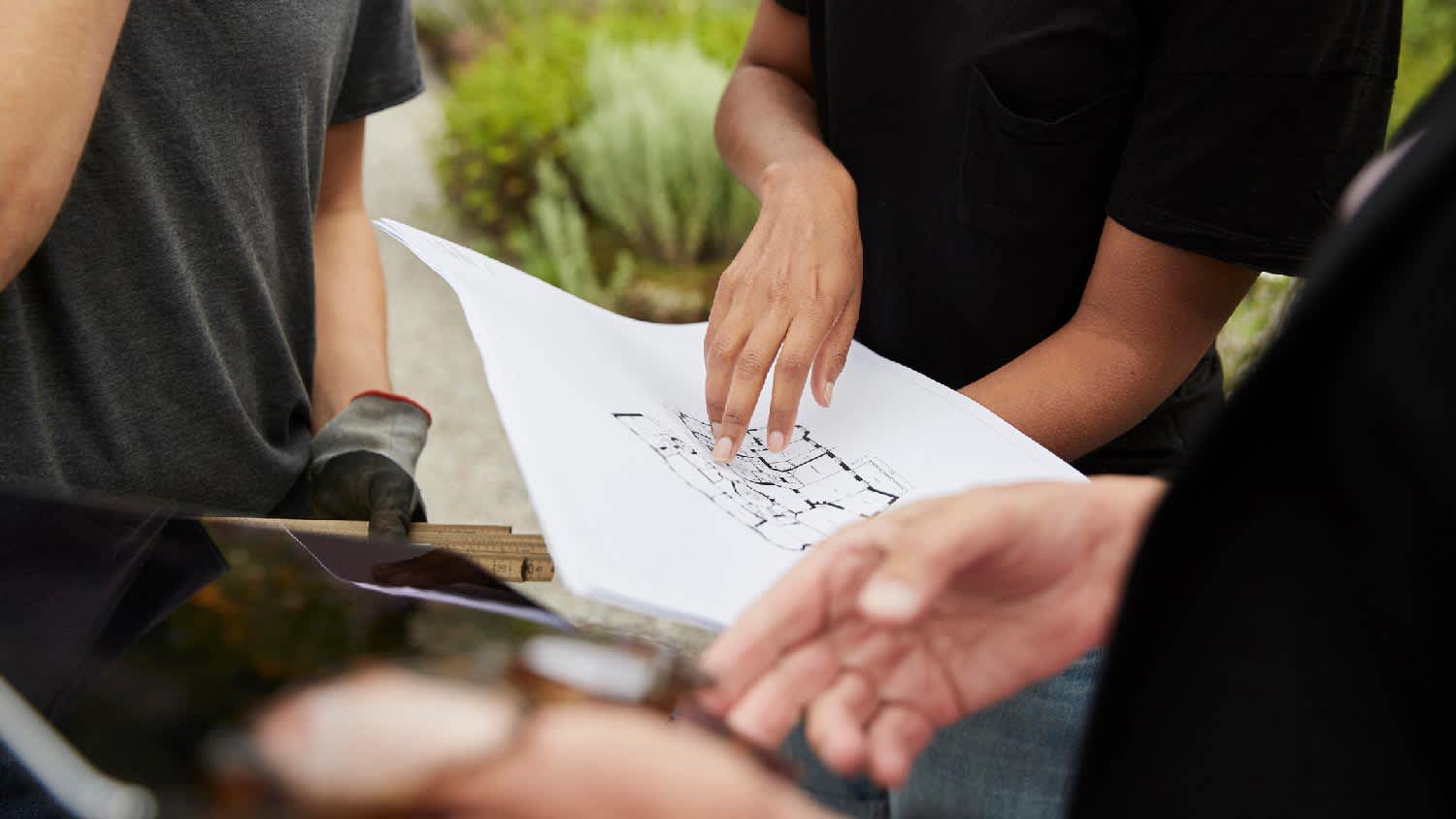 People discussing on a plot plan