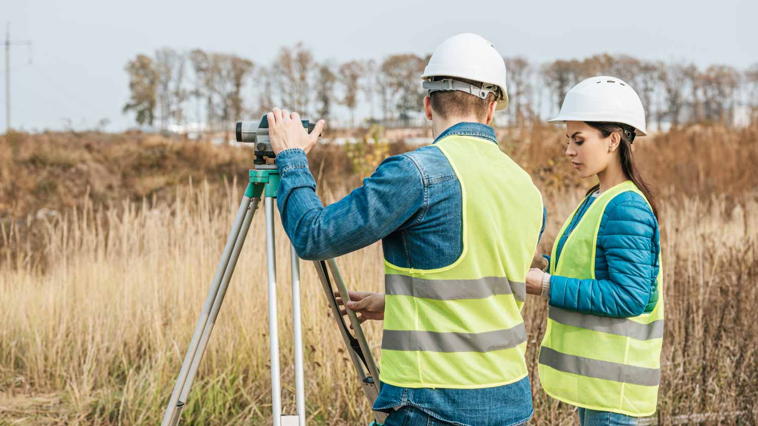 Surveyors working with digital level in field