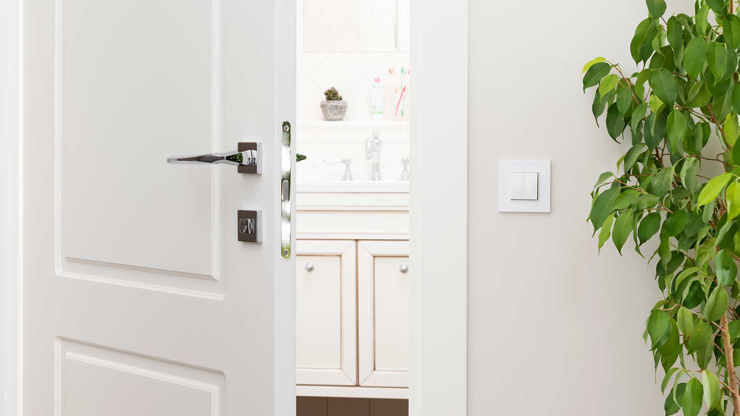 White bathroom door halfway open