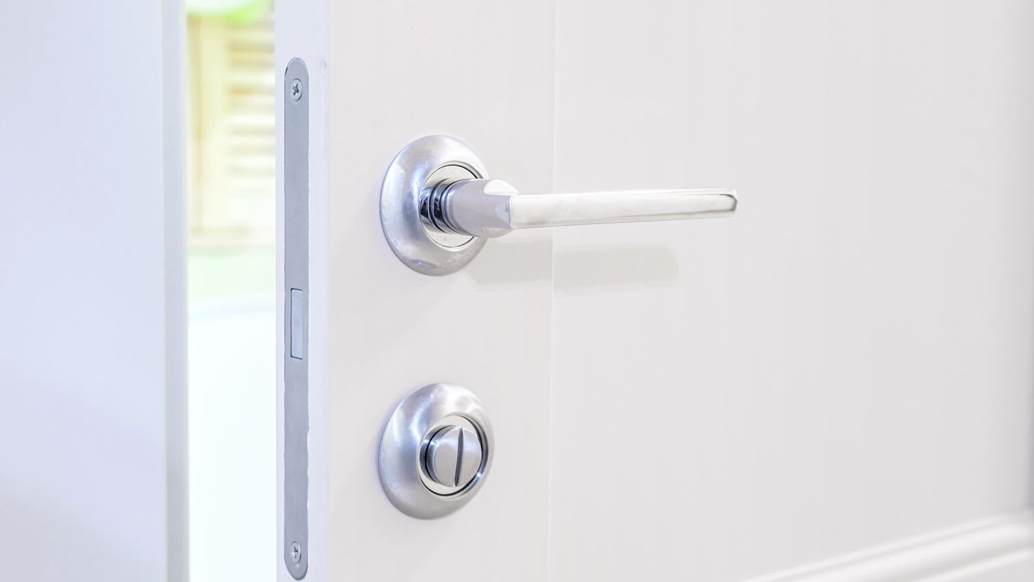 Wide door lever installed on a white door