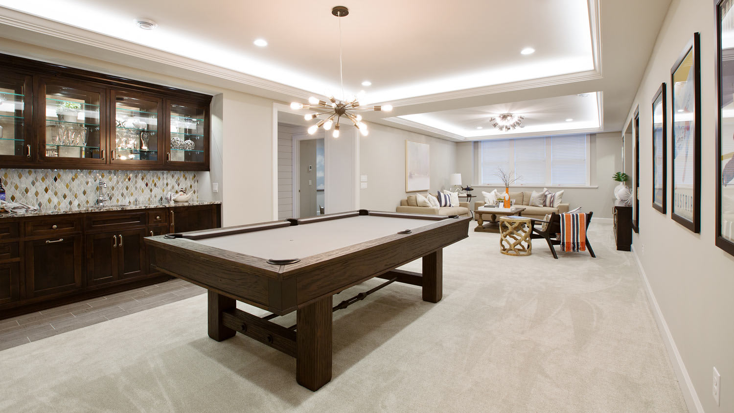 A basement turned into an entertainment room with a pool table