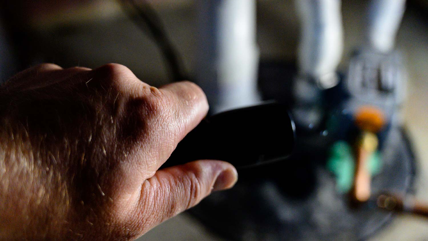 A person flashing light to a sump pump