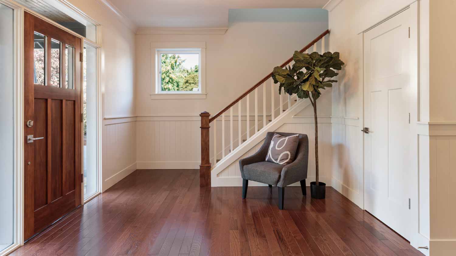 Armchair and tree in house entryway