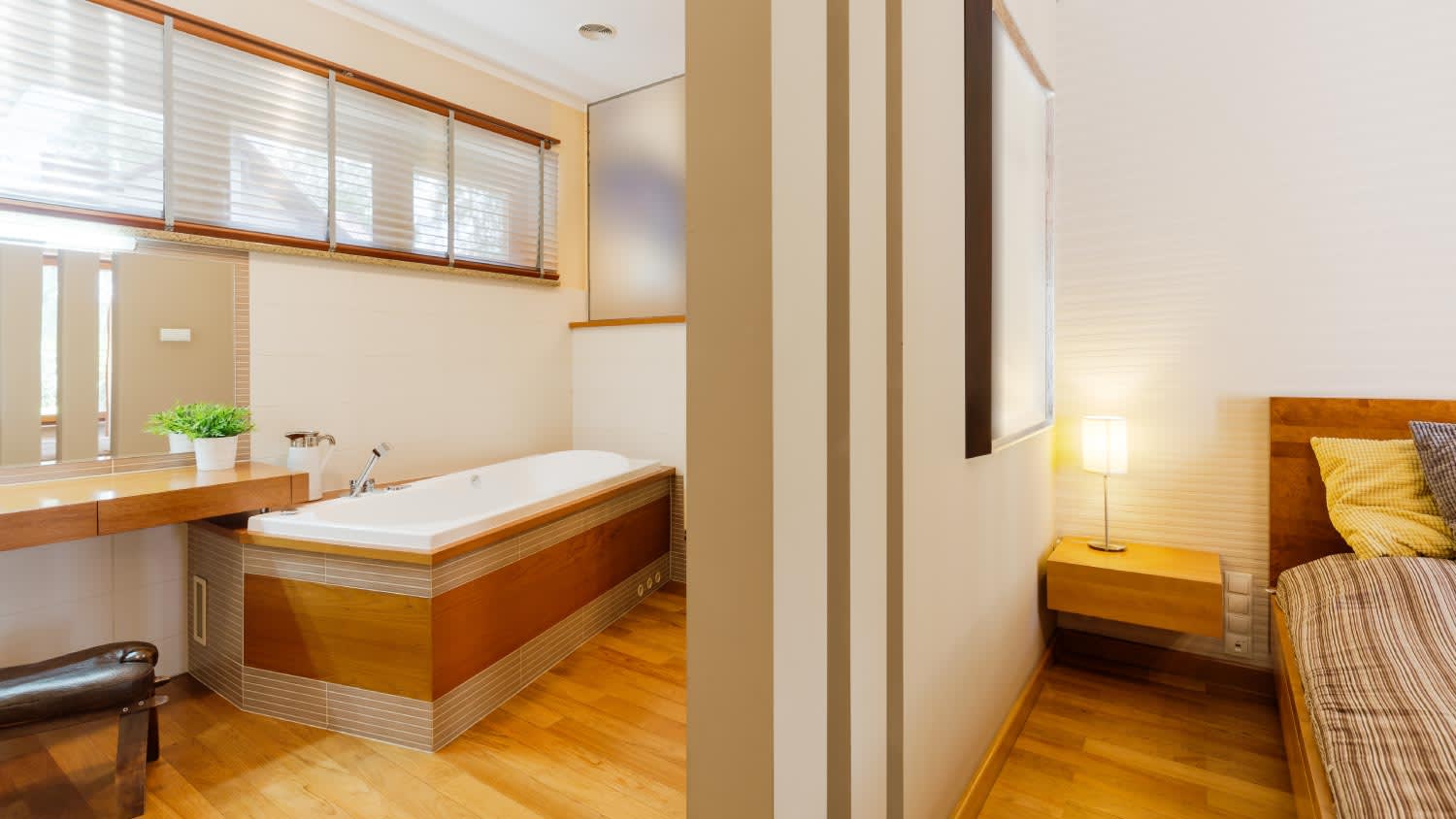 A bedroom with a bathroom