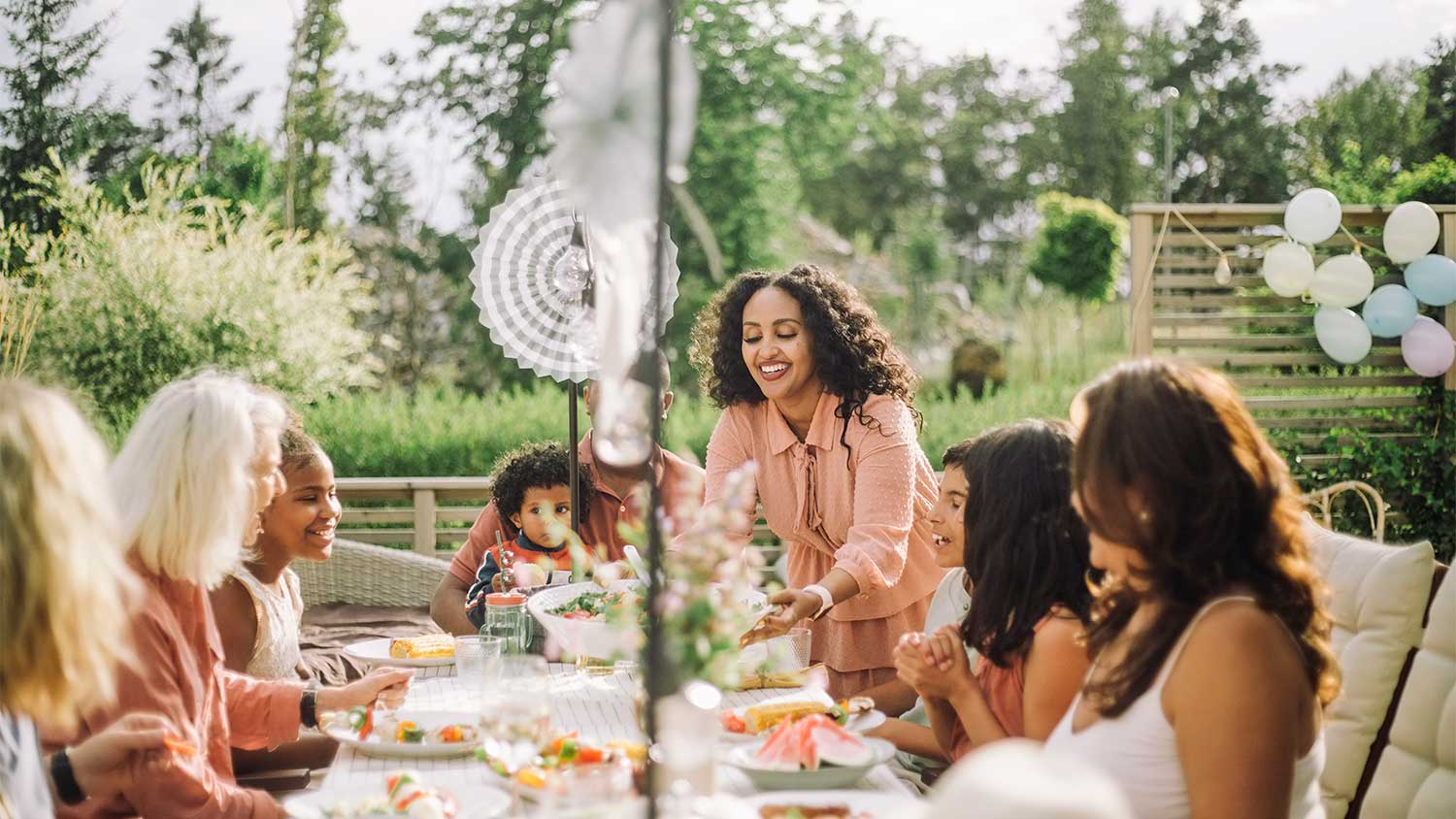 A family eats in a backyard