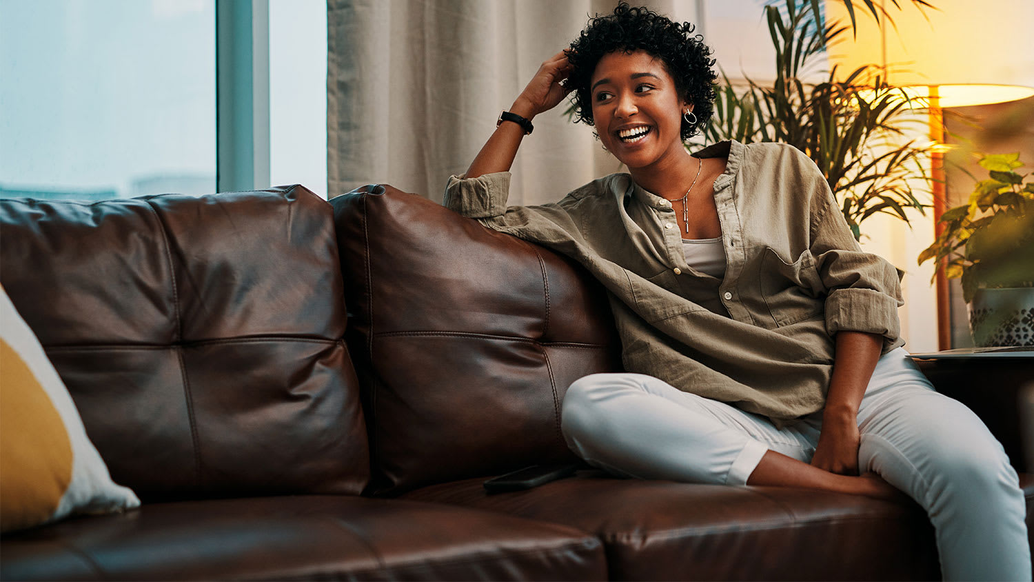 Woman sitting on leather couch