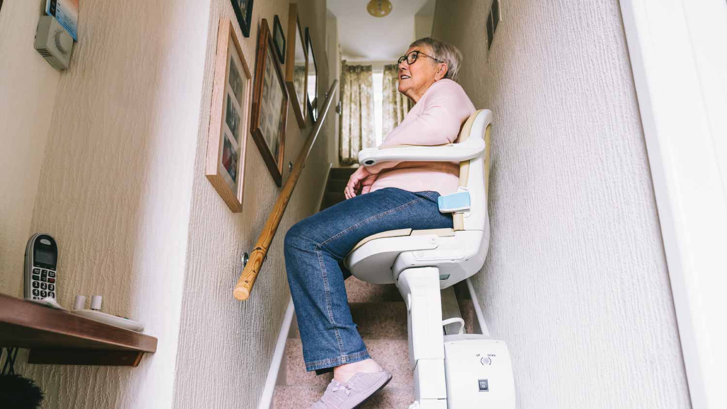 Senior woman using automatic stair lift