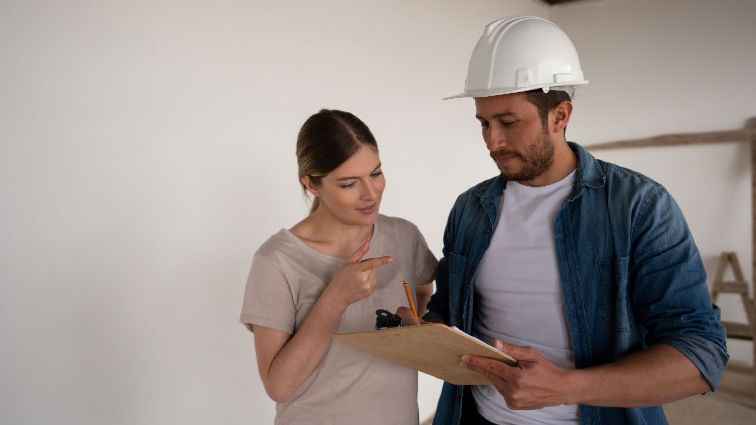 A woman talking to a contractor regarding the permit