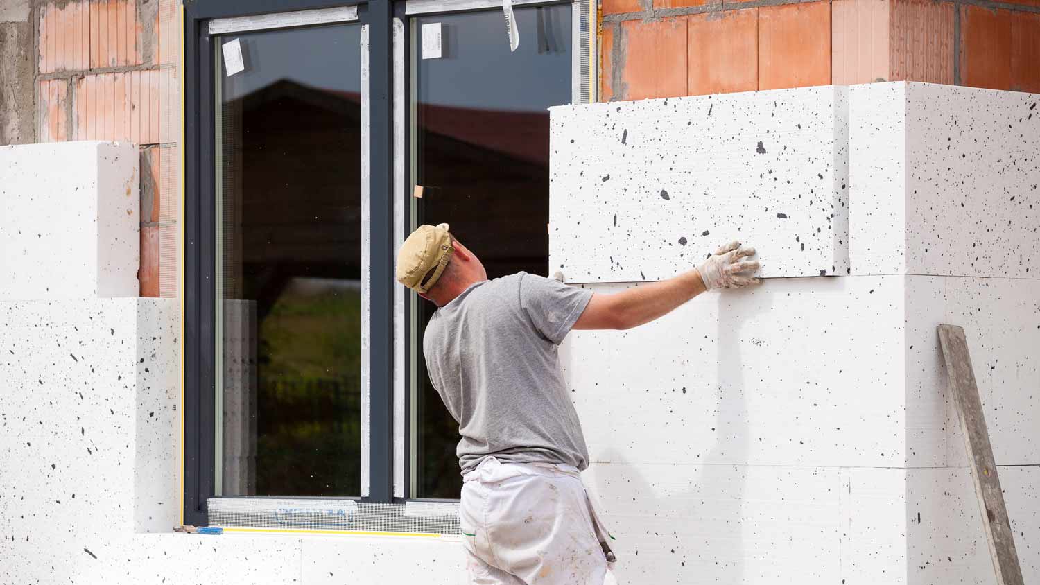 worker installing insulation board