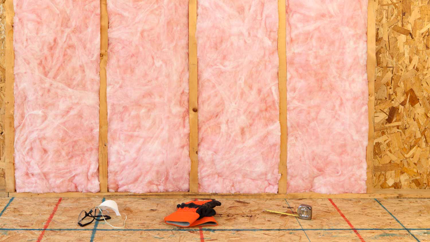 Wall with pink fiberglass insulation