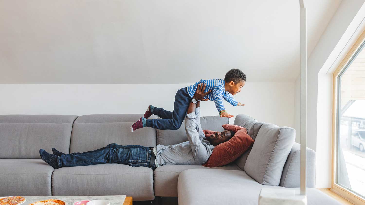 Father and son playing together in the living room