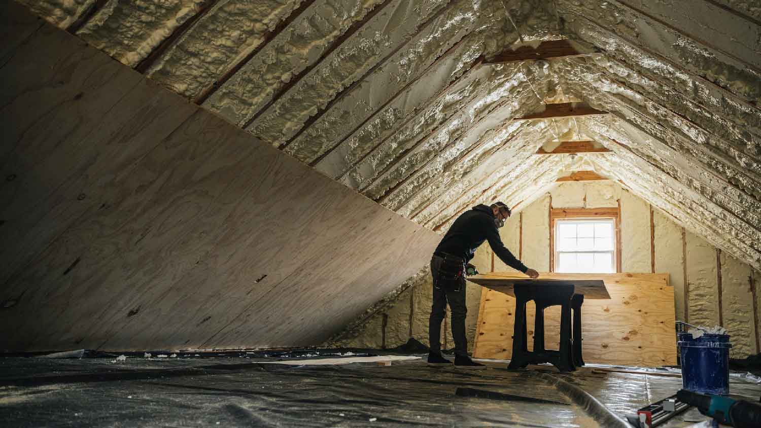 A person organizing an attic insulation removal