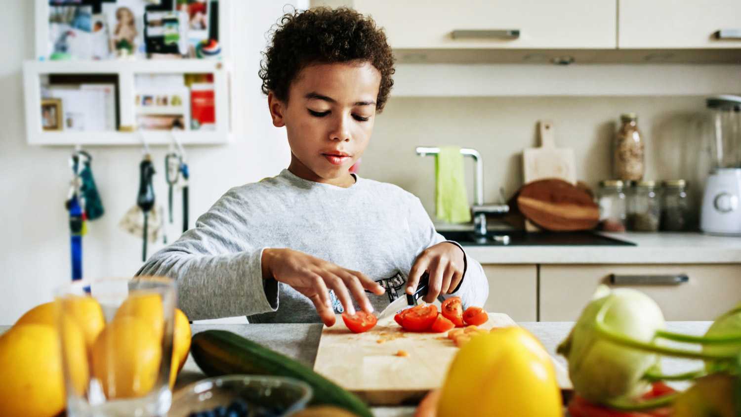 Young Boy Helping To Prepare Lunch At Home