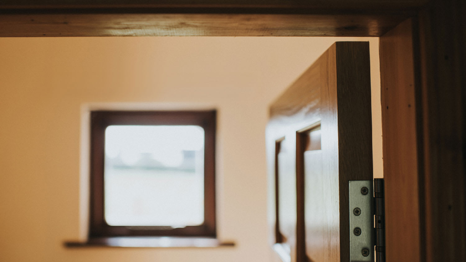 Close-up of a hinge on a wooden door