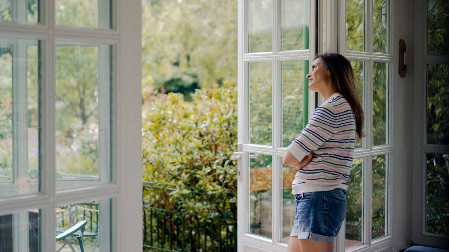 Woman looking out of terrace door