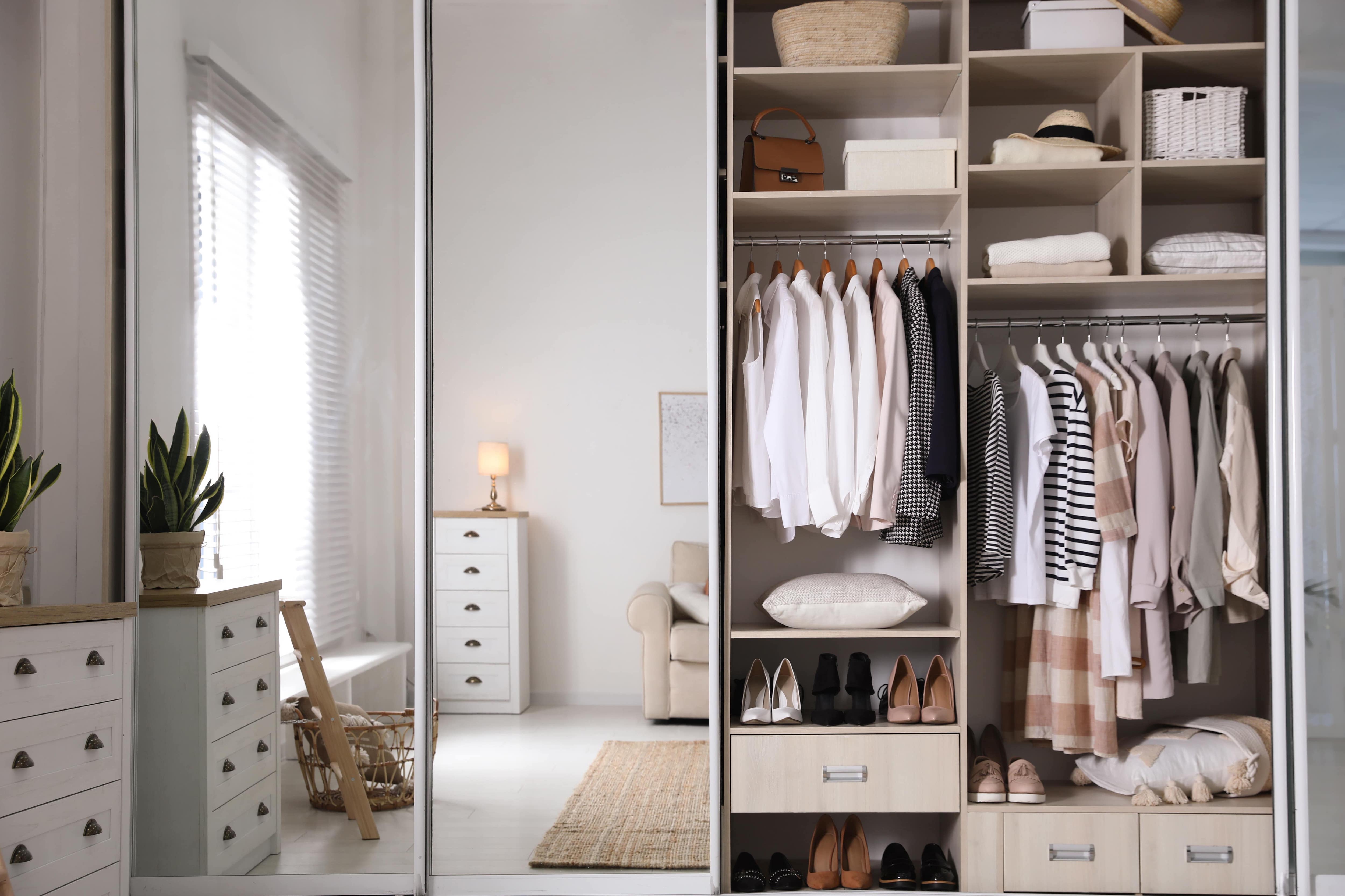 A bedroom with a set of sliding mirror closet doors