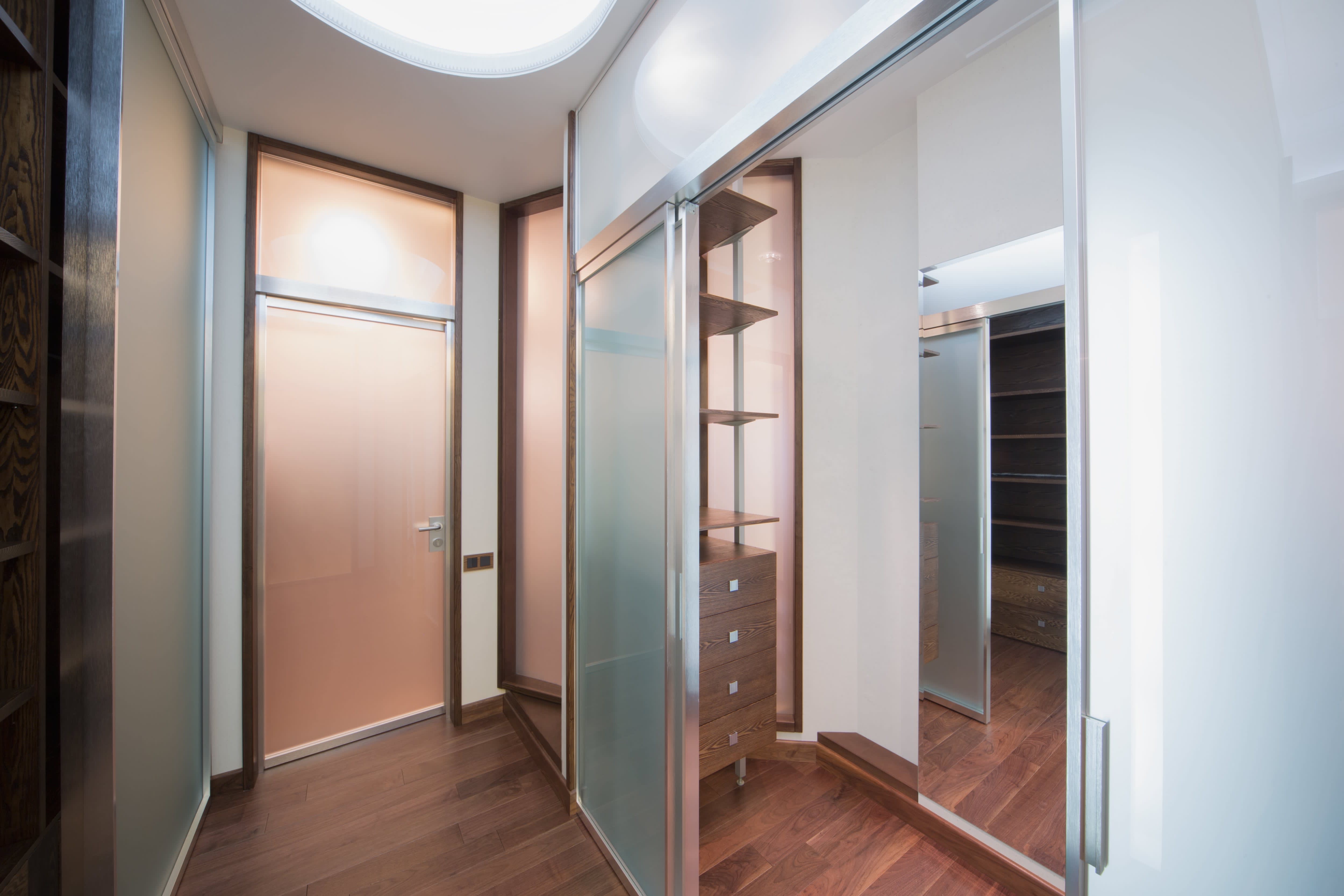 A modern closet with glass doors