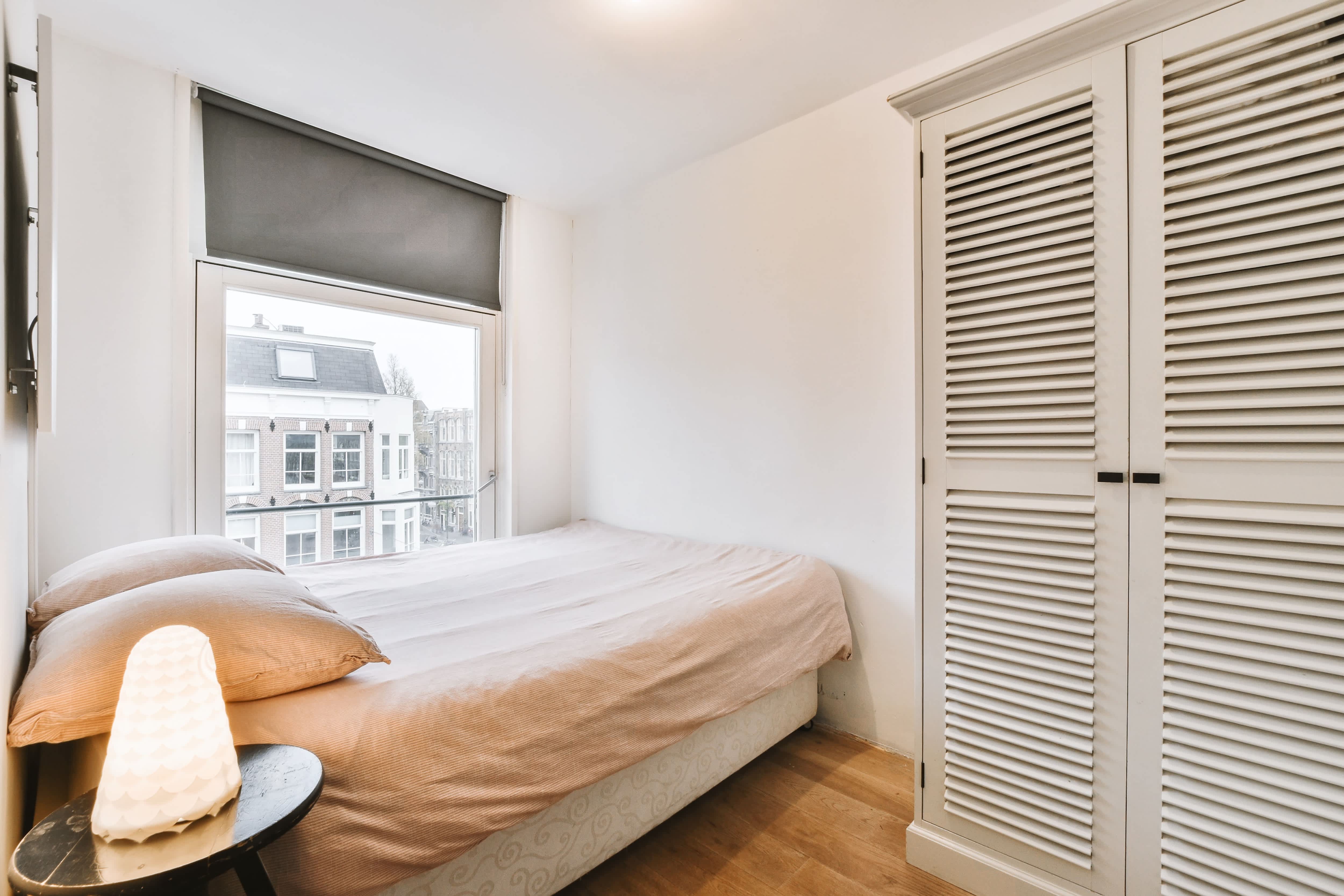 A wardrobe closet with louvered doors
