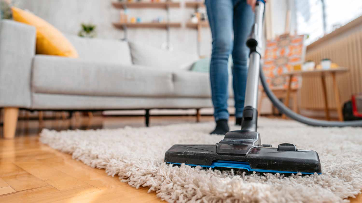 Woman vacuuming her apartment