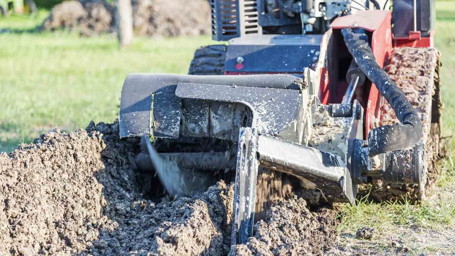 trencher machine slicing a trench